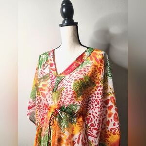 Pair of tropical print see-thru cover-ups